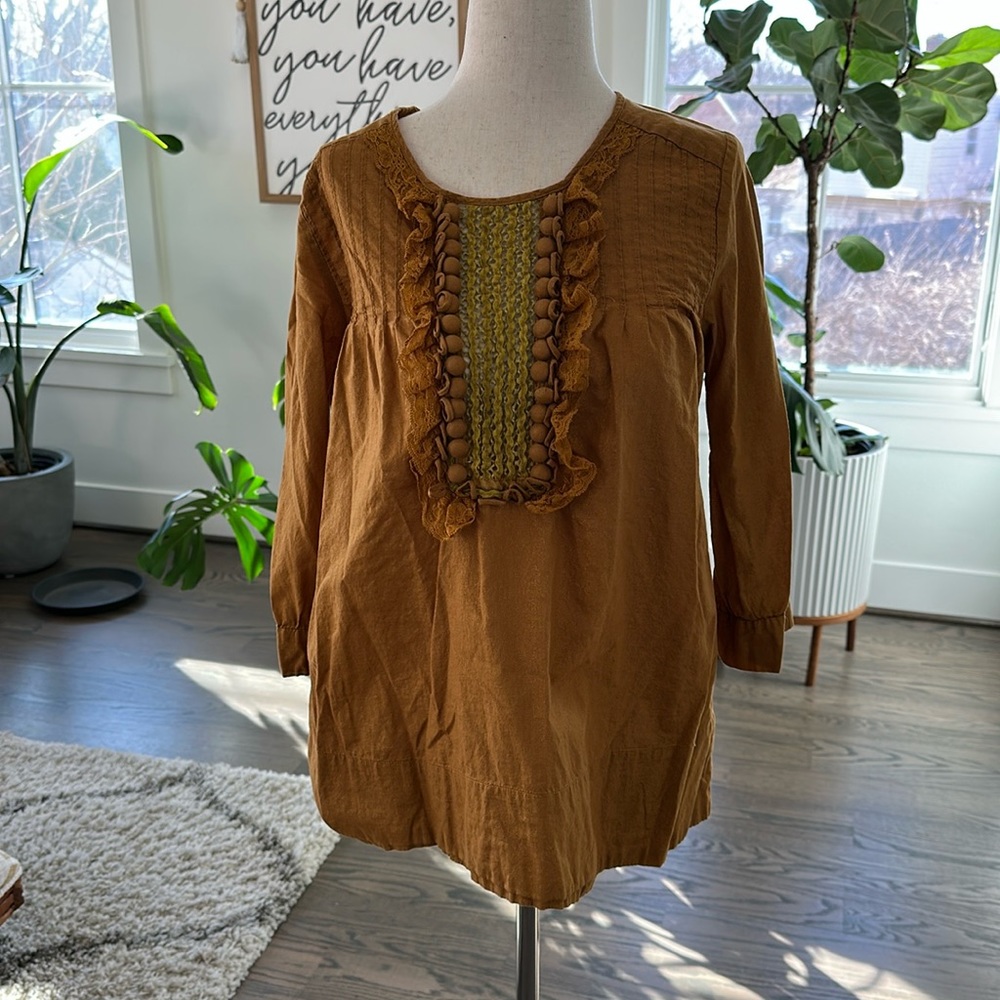 BCBG tunic style 3/4 sleeve top with covered button detail.